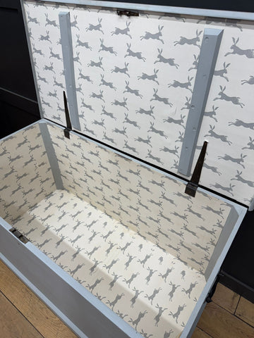 Gray hares-patterned antique painted blanket chest with light gray exterior and shoe storage lined interior