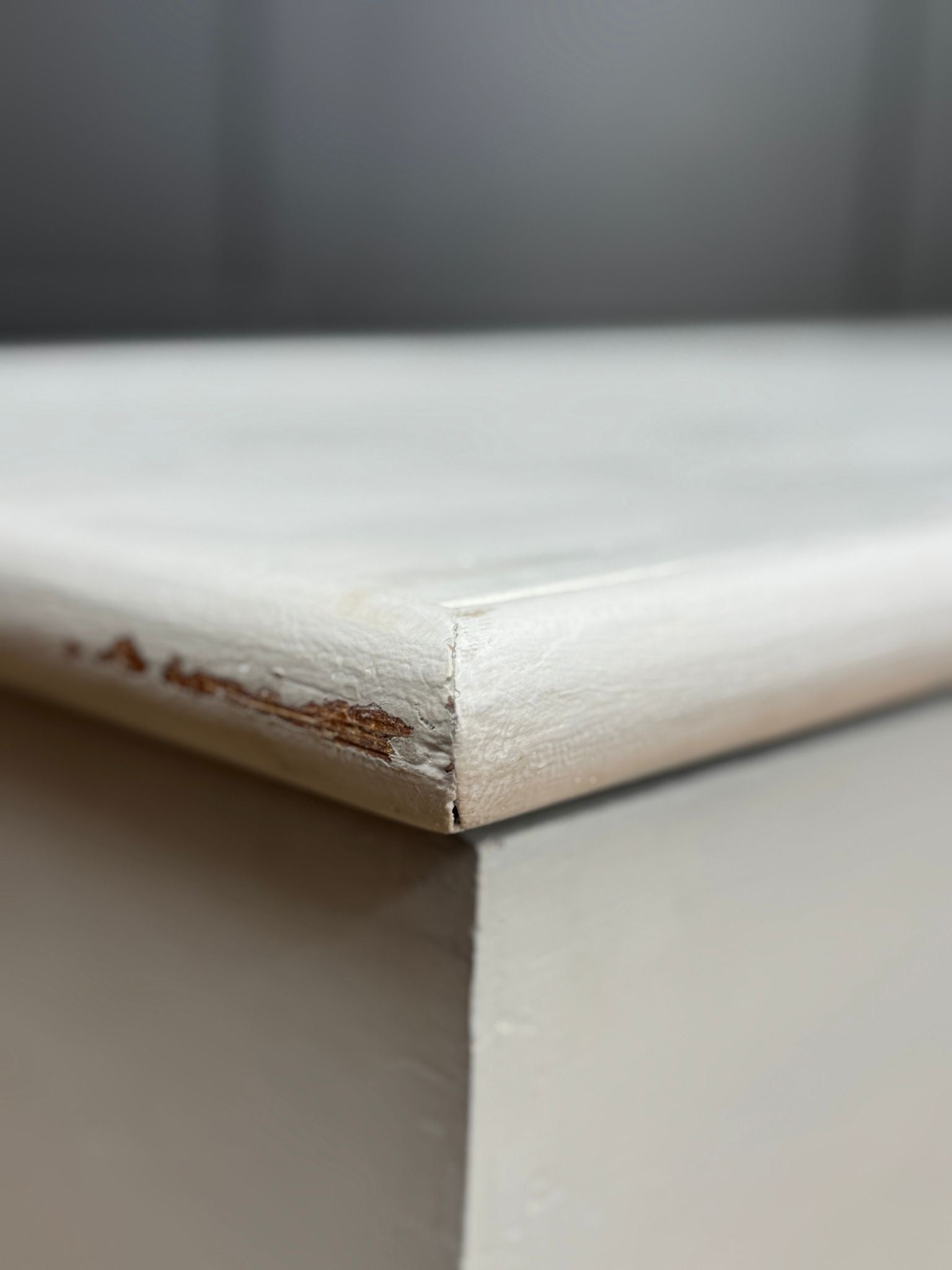 White painted wooden blanket chest with chipped paint revealing brown wood ideal for shoe storage and seating