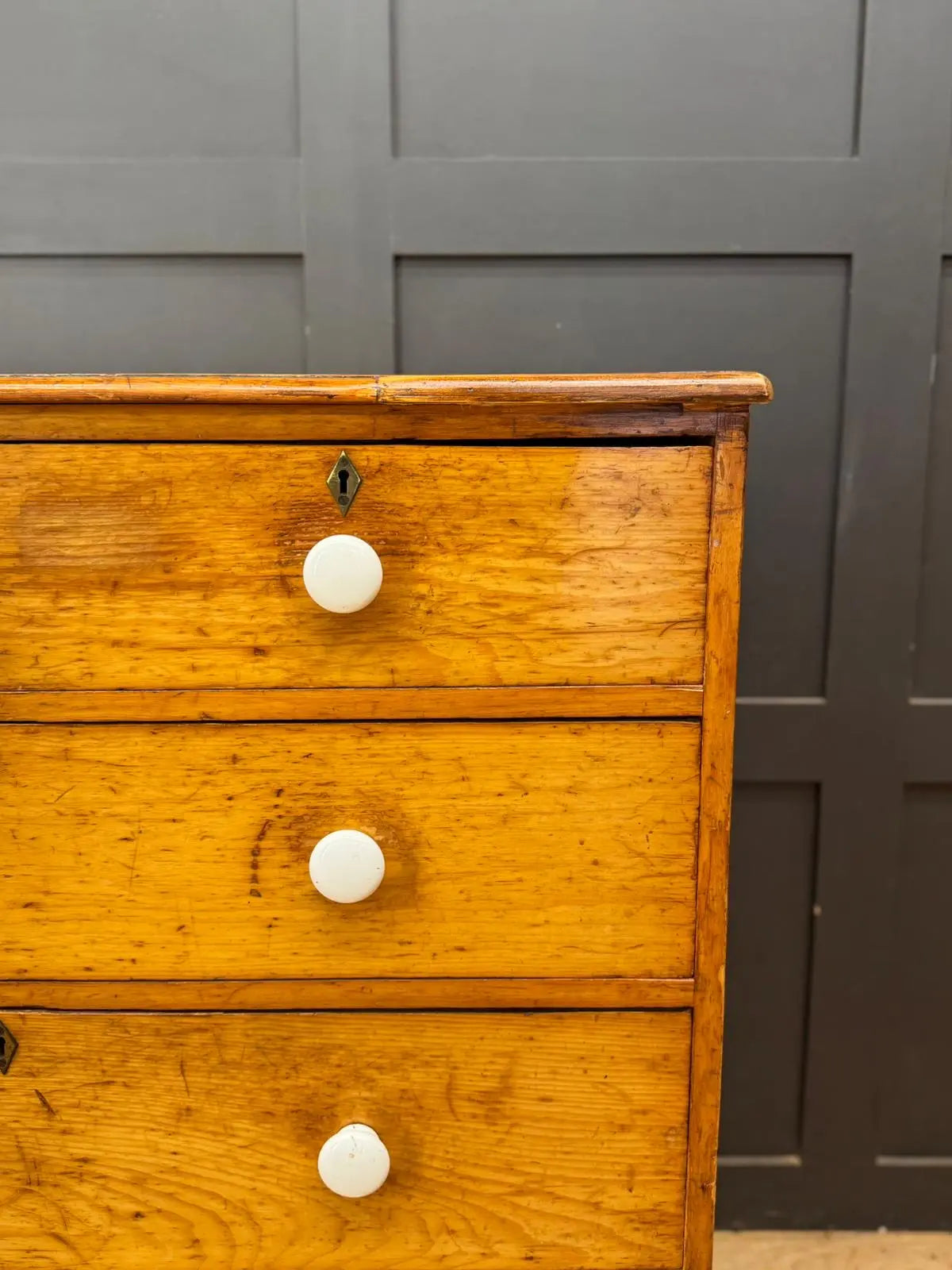 Antique oak chest of drawers with white ceramic knobs and brass keyholes perfect for country house pine chest storage