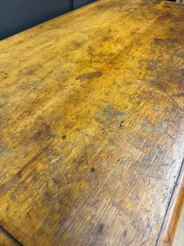A well-worn golden-yellow pine chest with scratches perfect for vintage country house storage and decor