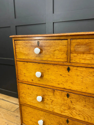 Antique yellow oak country house chest of drawers with white ceramic knobs and black metal keyholes pine chest