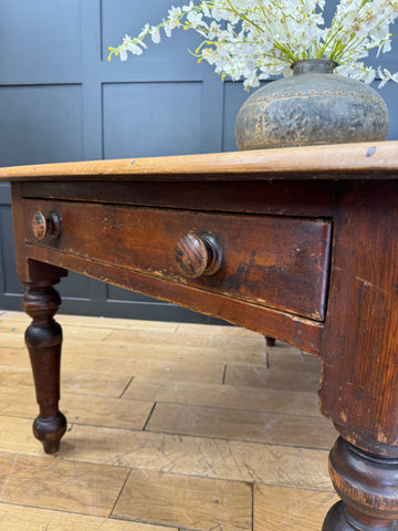 Antique pine kitchen table with distressed dark brown finish ornate legs and two drawers with brass knobs