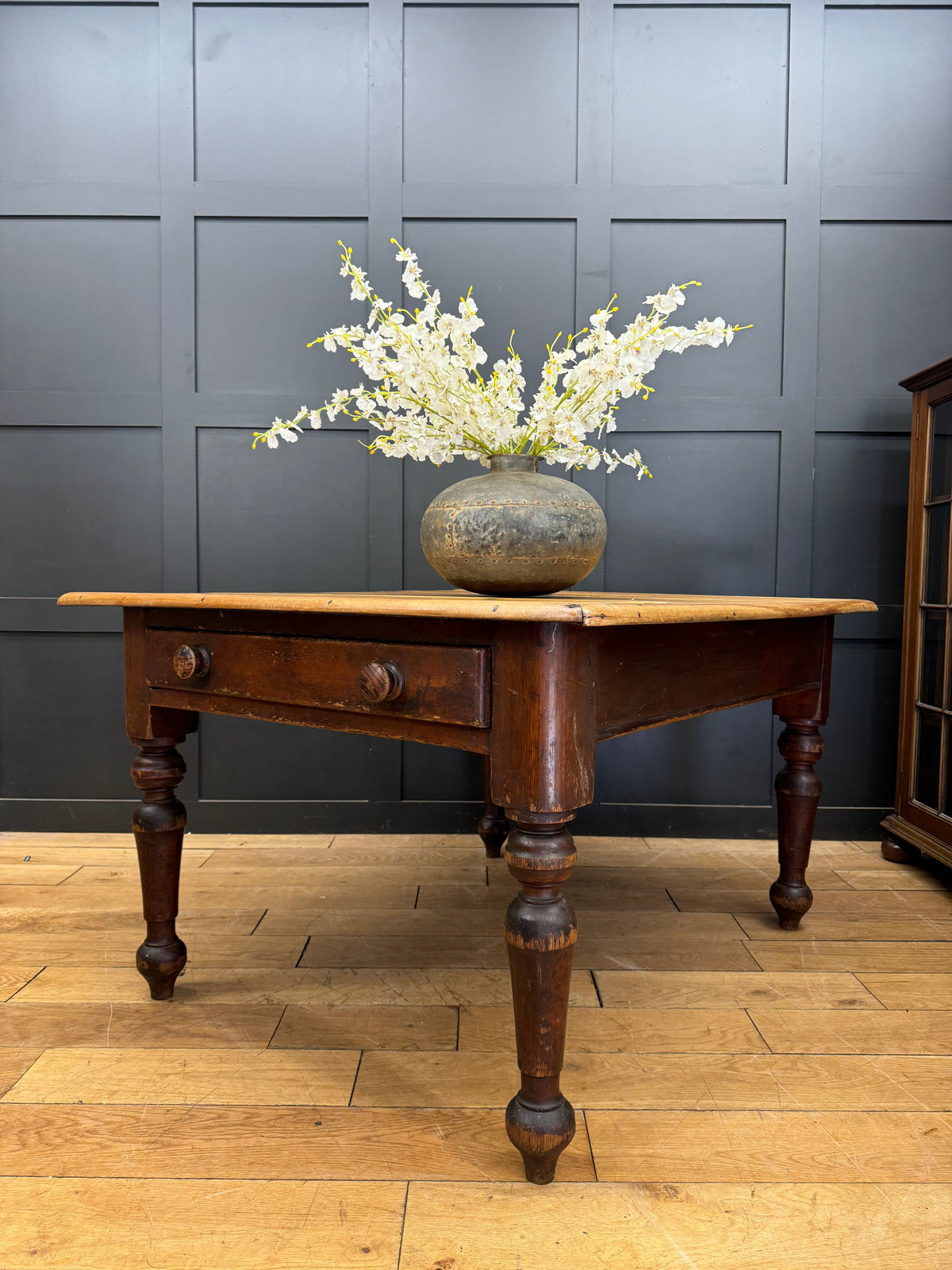 Antique pine kitchen table with dark wood rustic finish turned legs and central drawer with round knobs