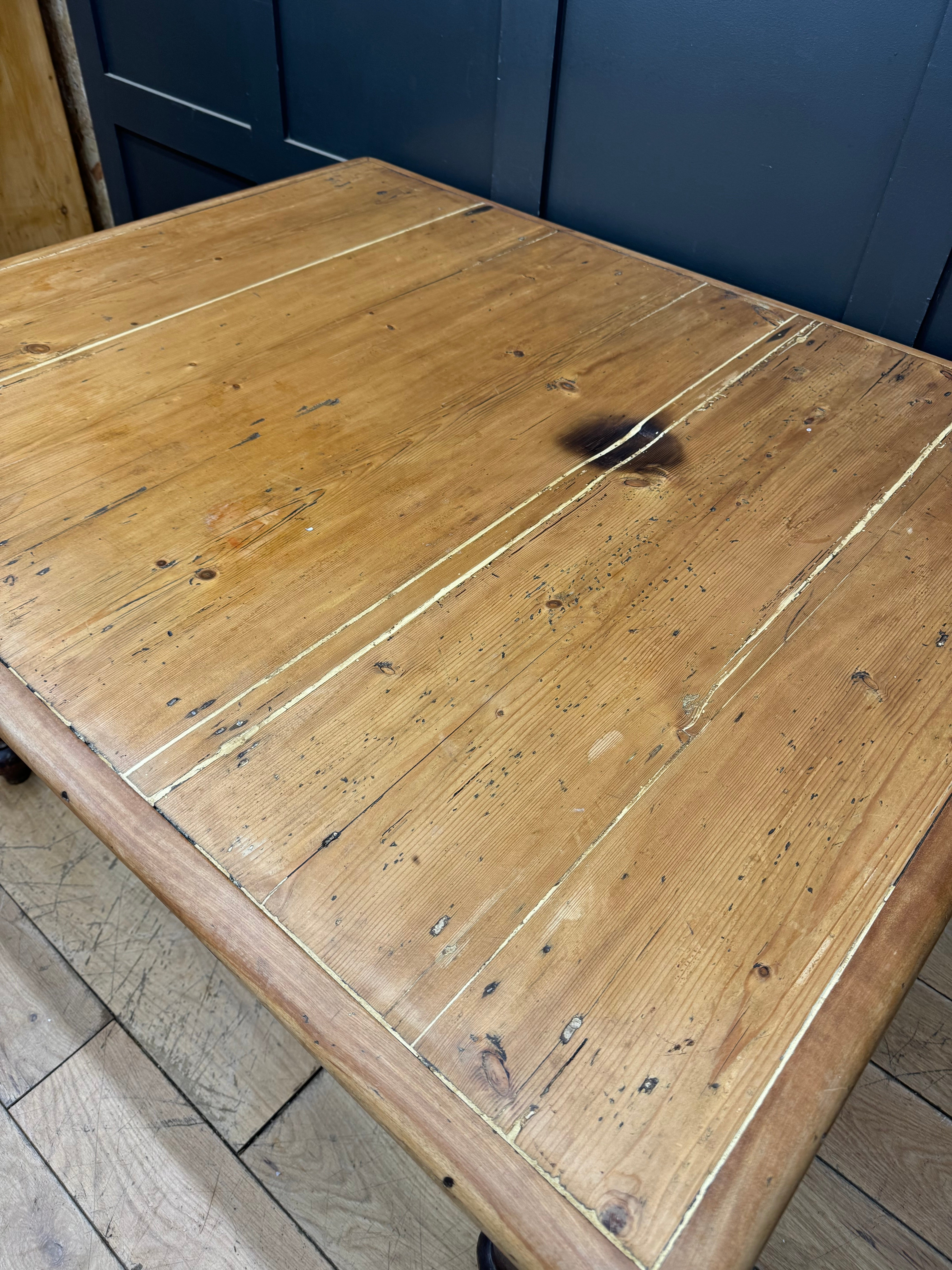 Antique pine kitchen table with rustic light brown wood grain and natural imperfections perfect for farmhouse decor