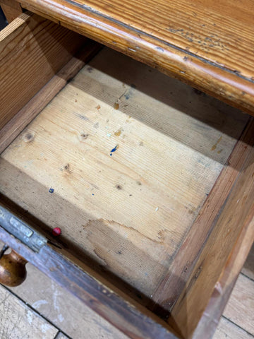 Rustic wooden drawer with visible grain and wear in antique pine pedestal desk dressing table with cupboards and drawers