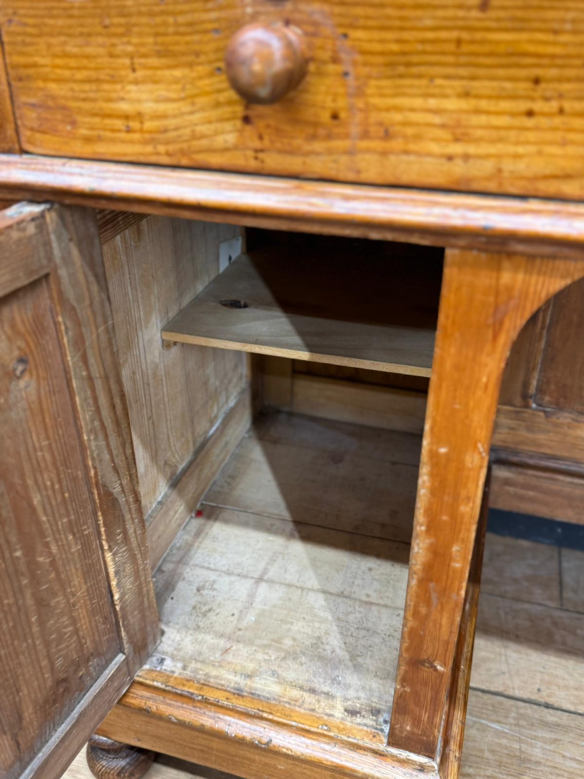 Antique pine pedestal desk dressing table with round wooden knob drawer and visible pine grain patterns