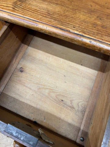 A rustic antique pine pedestal desk drawer with warm natural finish and visible grain patterns