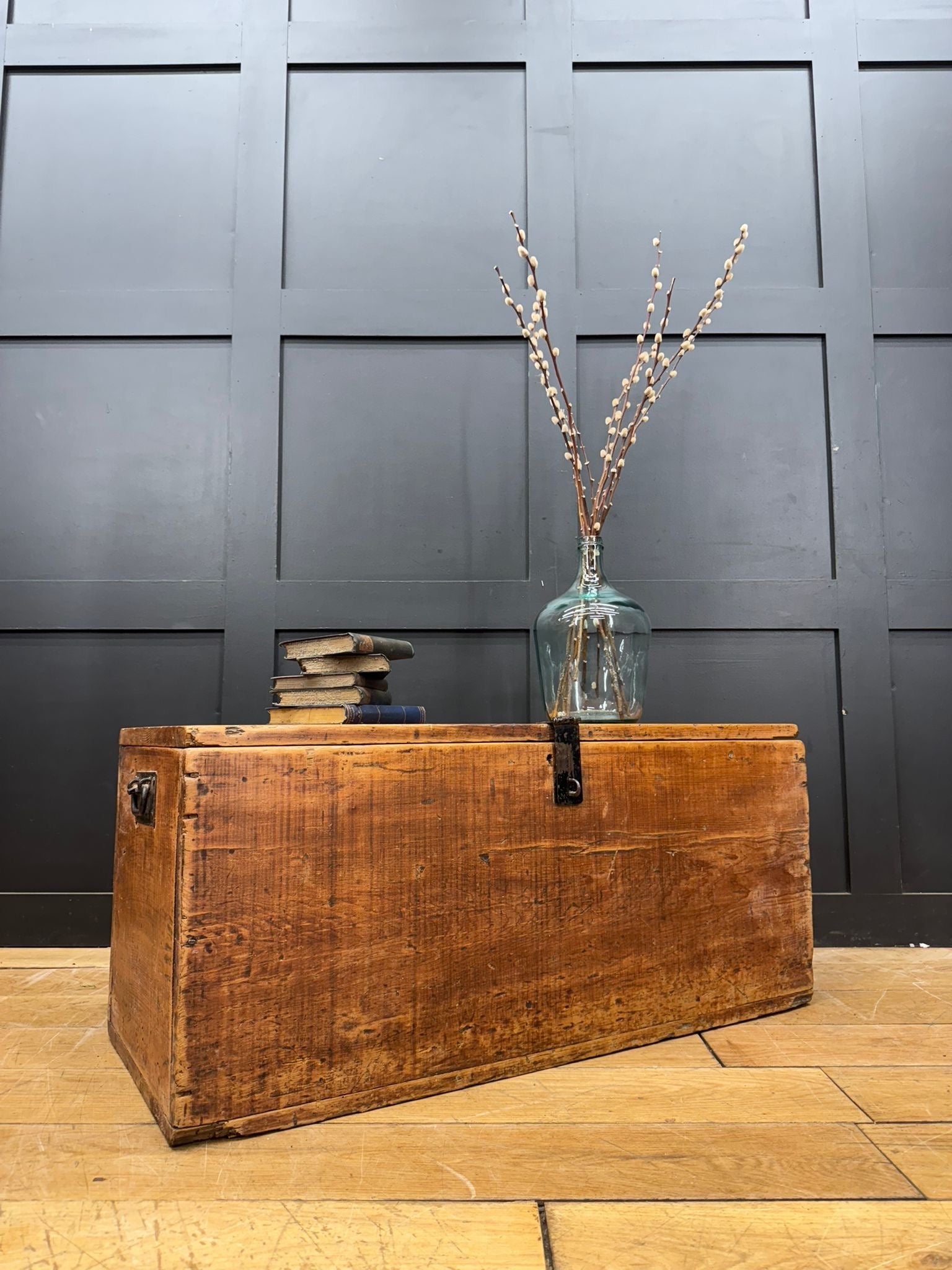 A rustic antique pine storage chest with a warm brown finish and visible wood grain perfect as a blanket box or coffee table