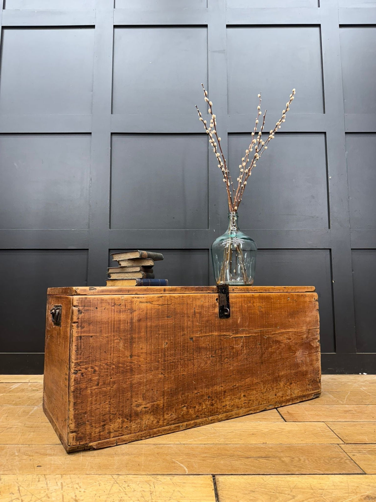A rustic antique pine storage chest with a warm brown finish and visible wood grain perfect as a blanket box or coffee table