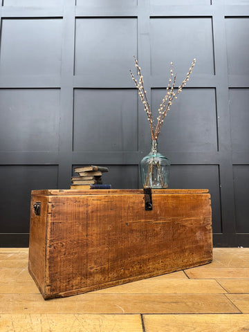 A rustic antique pine storage chest with a warm brown finish and visible wood grain perfect as a blanket box or coffee table