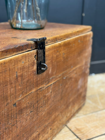 Rustic antique pine storage chest with weathered warm brown finish and black metal latch for blankets or coffee table