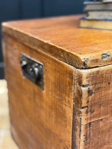 Rustic antique pine storage chest with weathered wood grain and dark metal latch perfect as blanket box or coffee table trunk