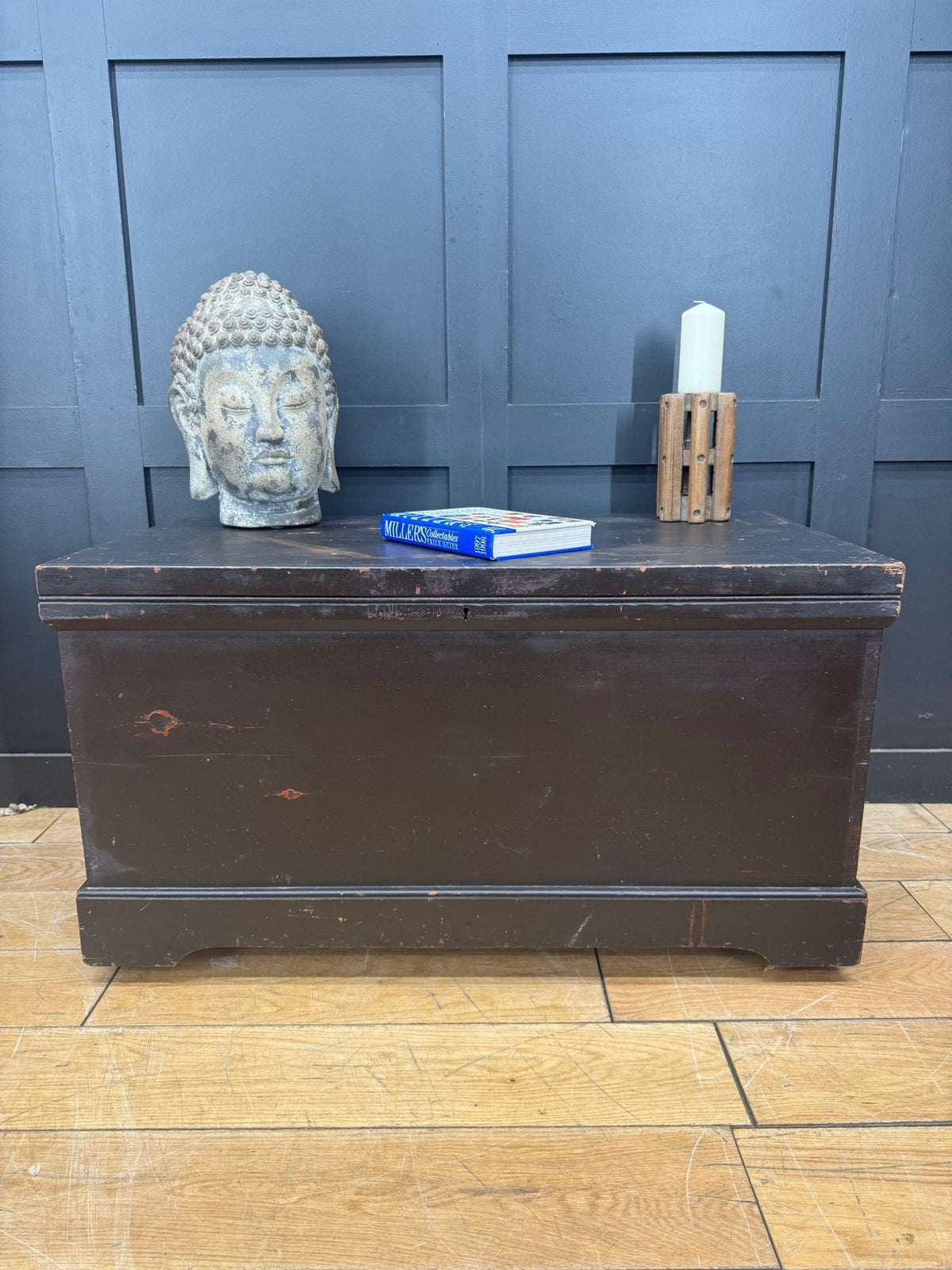 Dark brown wooden antique pine trunk with worn finish and classic design used as blanket box or coffee table