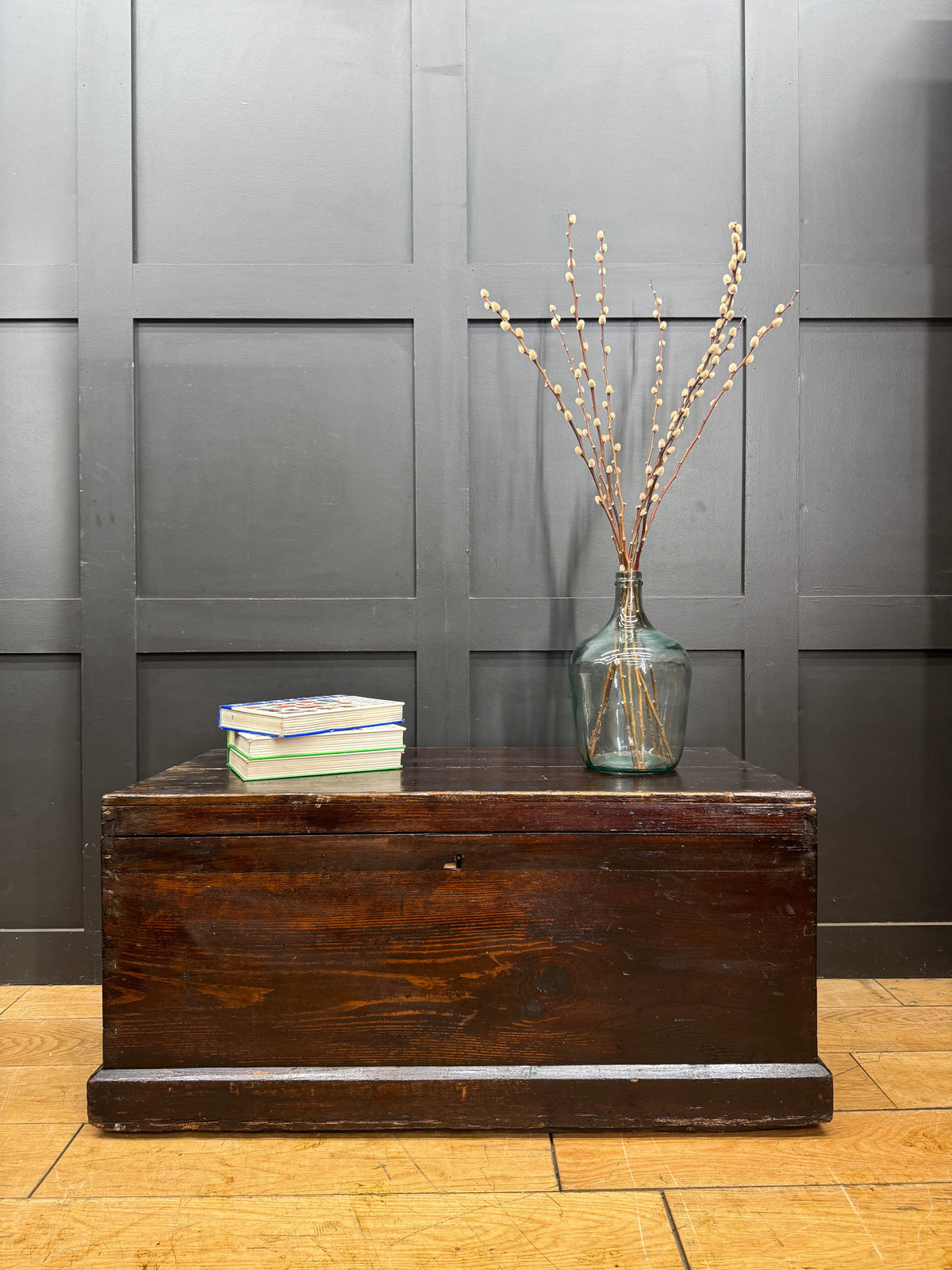 Dark brown antique pine trunk chest with worn finish and metal latch perfect as a coffee table or storage box