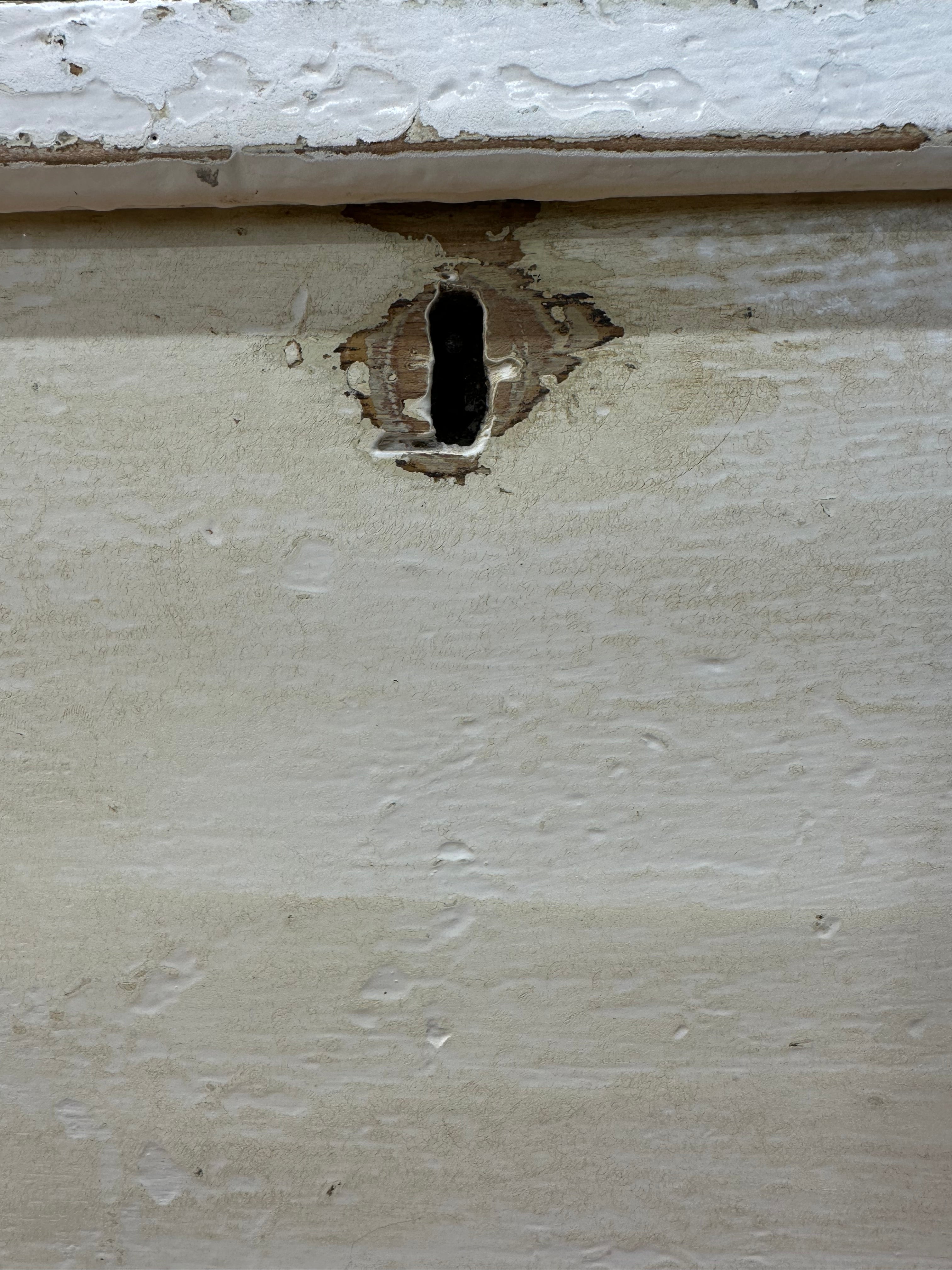 A weathered off-white painted pine trunk with a dark worn keyhole perfect as an antique blanket box or sideboard
