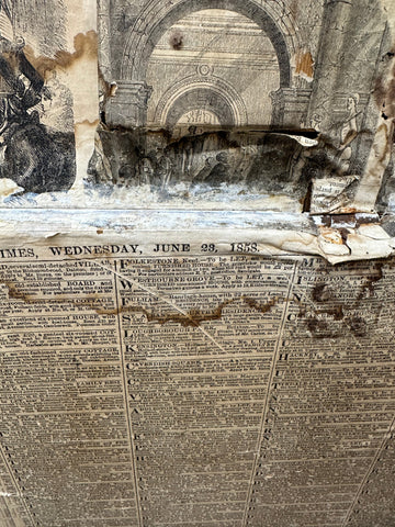 A weathered sepia toned 1855 london newspaper on aged paper featured inside an antique pine trunk blanket box sideboard