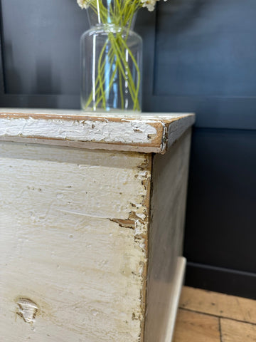 Antique white painted pine trunk with chipped paint and visible wood grain perfect as a blanket box or sideboard