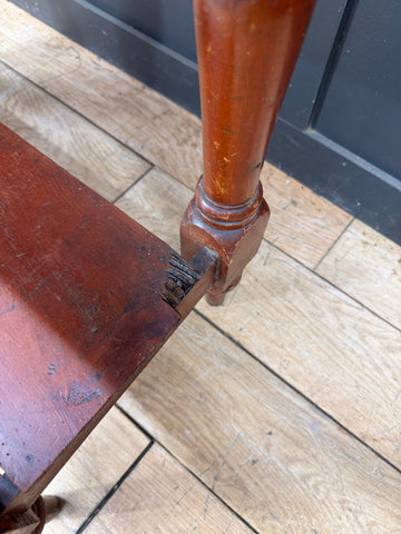 A worn reddish brown late victorian pine washstand table leg with turned design and wooden knobs visible signs of age