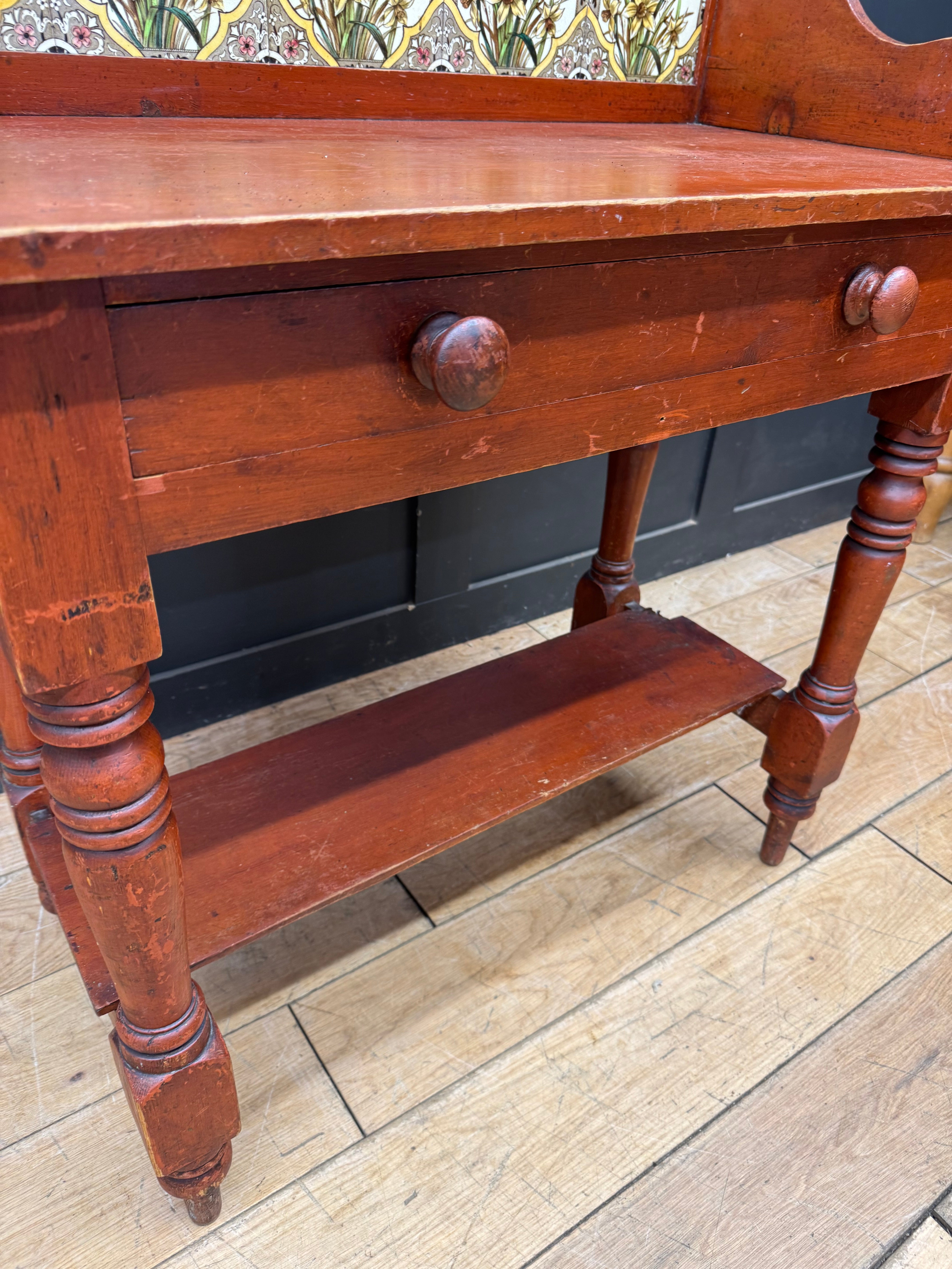 Antique late victorian pine washstand side table with reddish brown wood, carved legs, and round wooden knobs