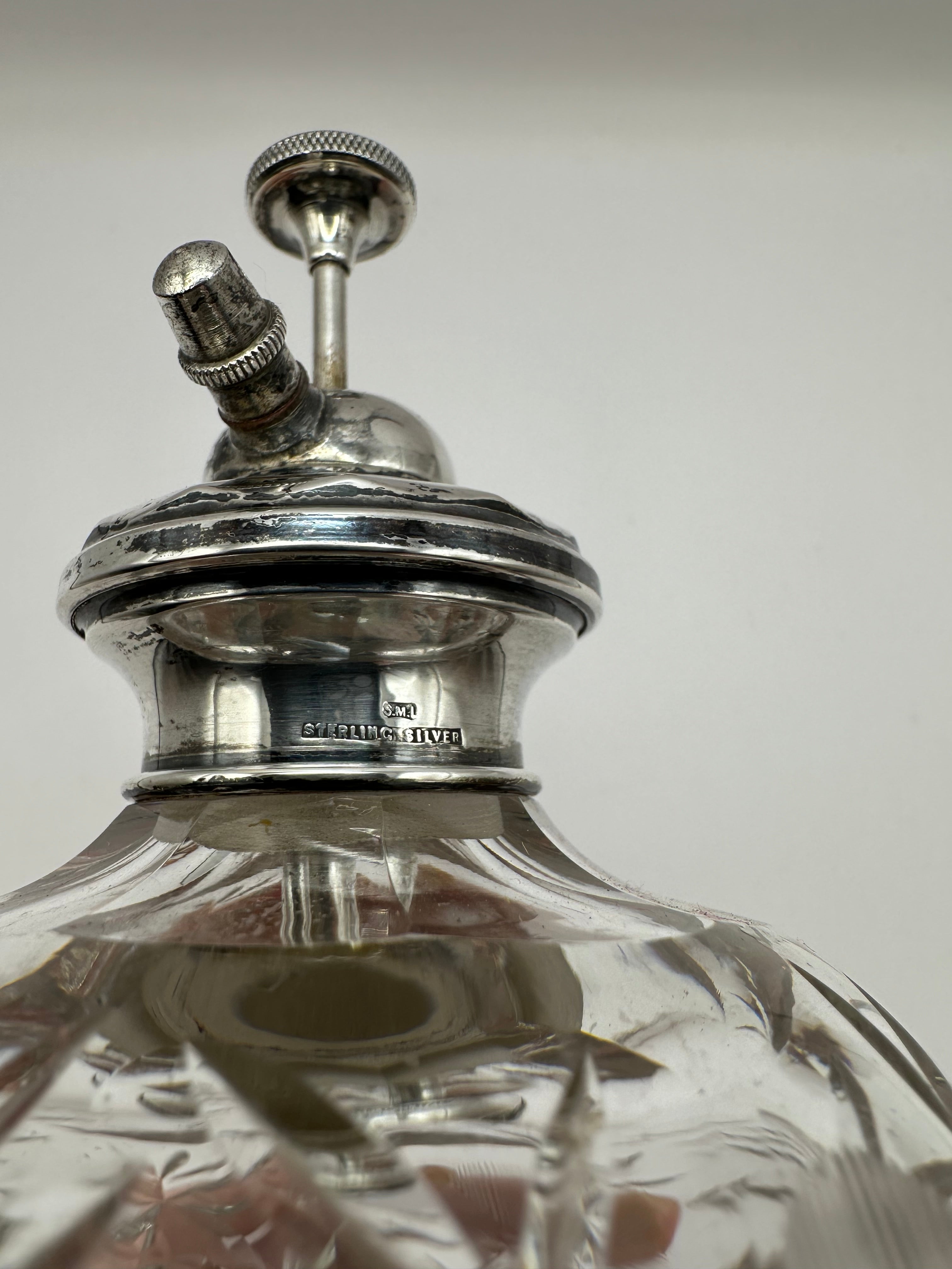 Antique silver topped cut glass scent atomiser bottle with sterling silver spray and intricate engraved detailing