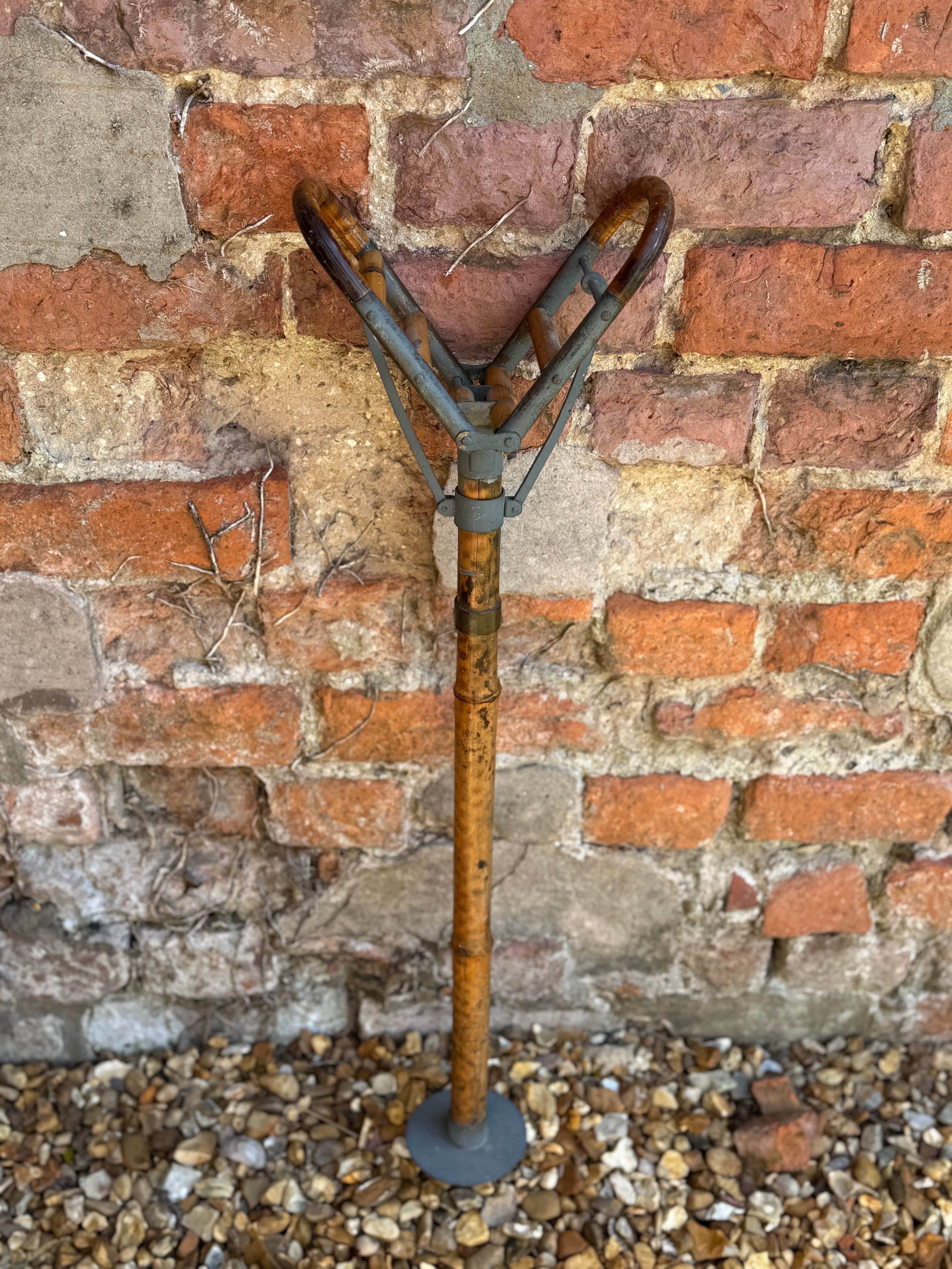 Vintage-style antique victorian bamboo shooting stick with rusted metal and weathered bamboo sporting cane design