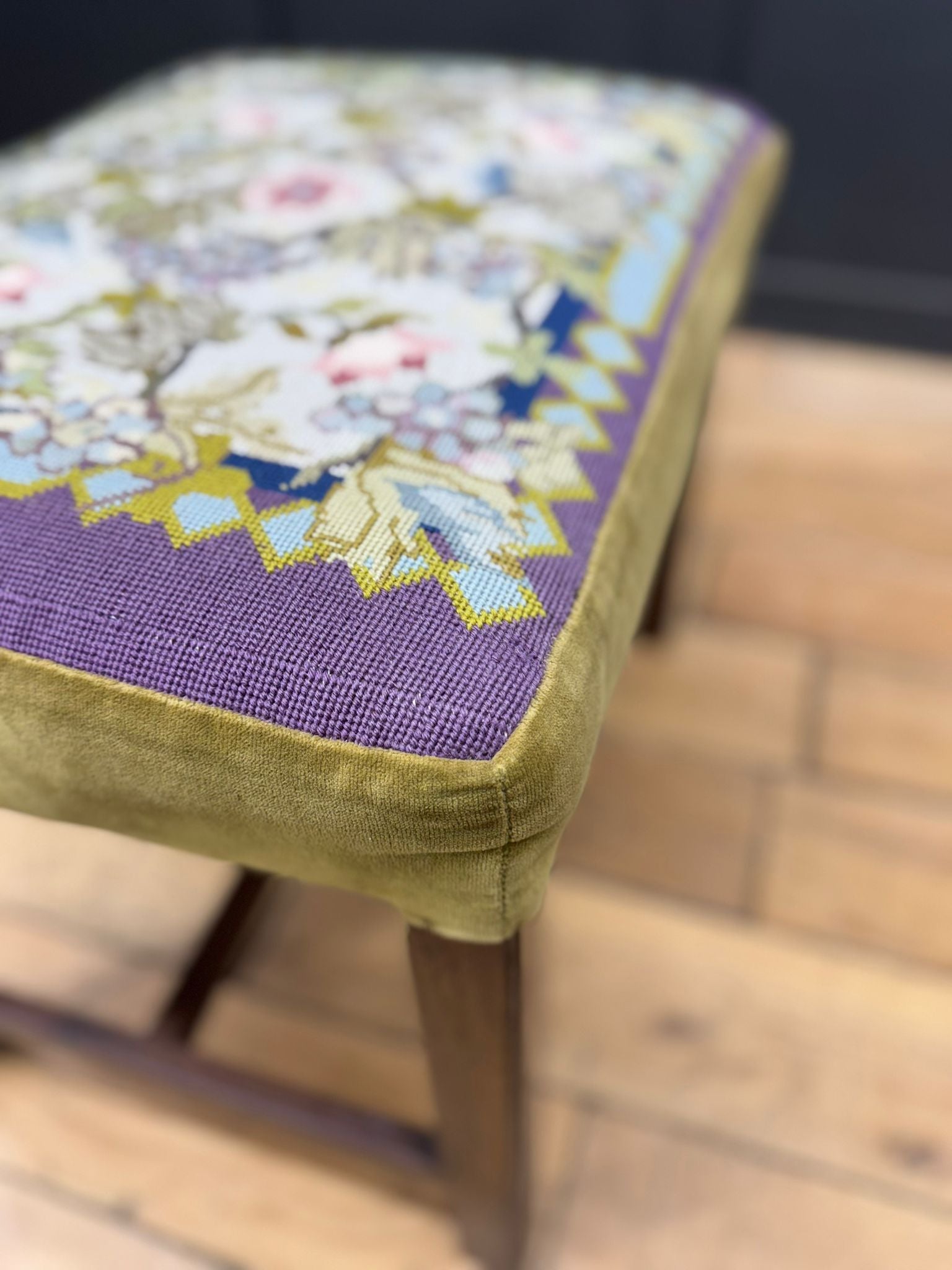 Antique victorian upholstered stool with pastel floral needlepoint seat and mahogany legs with velvet trim