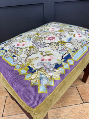 Antique victorian upholstered stool with floral needlepoint cushion in pastel hues and mahogany legs