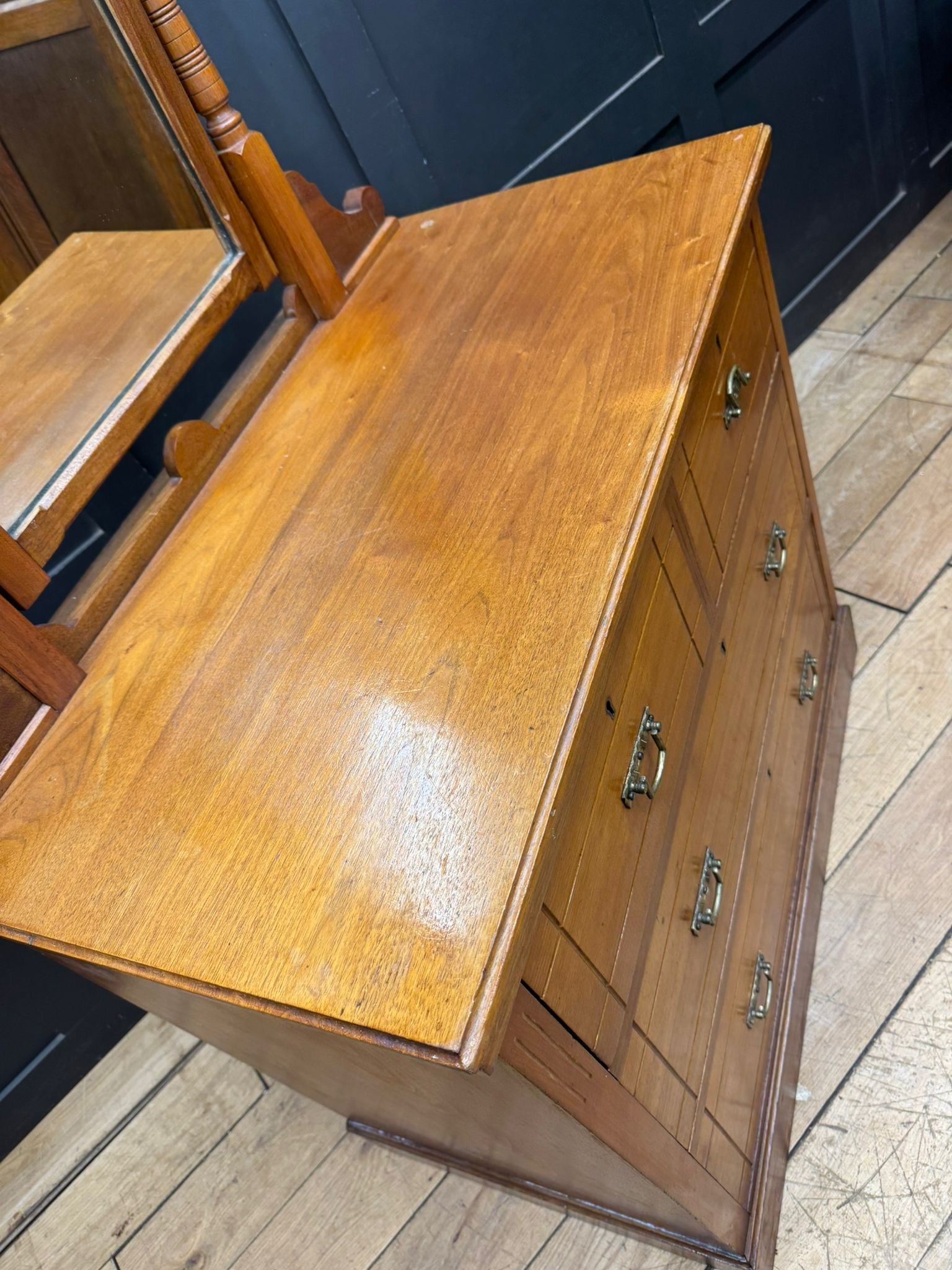 Antique walnut chest of drawers by Maple & Co with polished amber drawer fronts and ornate brass handles