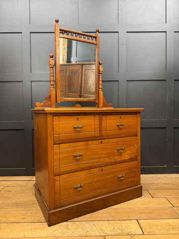 Antique walnut chest of drawers with oak vanity, matching mirror, and brass handles on drawer fronts by Maple & Co