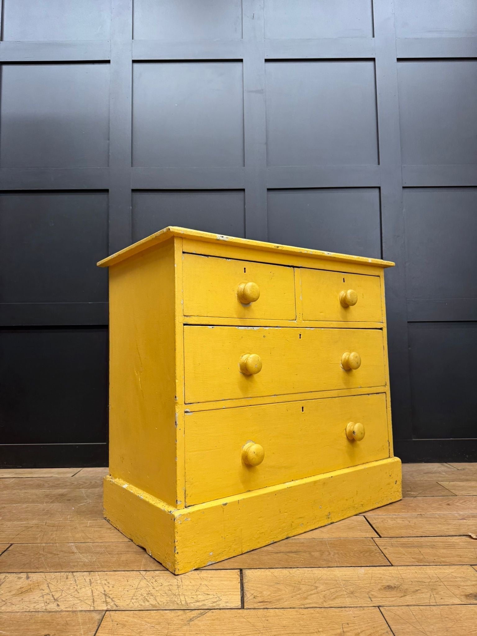 Bright yellow pine chest of drawers with three tiers and round knobs perfect for farmhouse bedroom storage