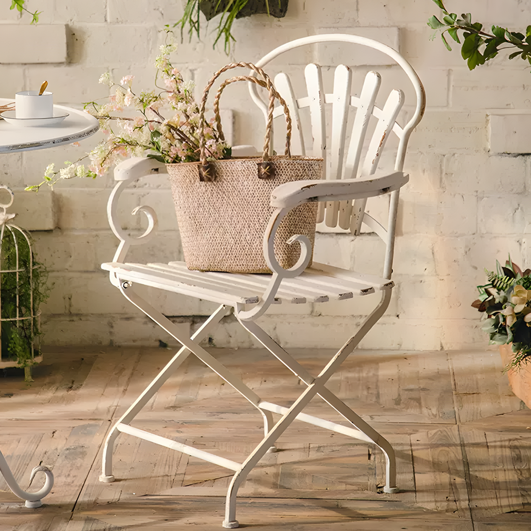 White wrought iron folding chair with ornate scrollwork and distressed finish from antonia outdoor garden dining set