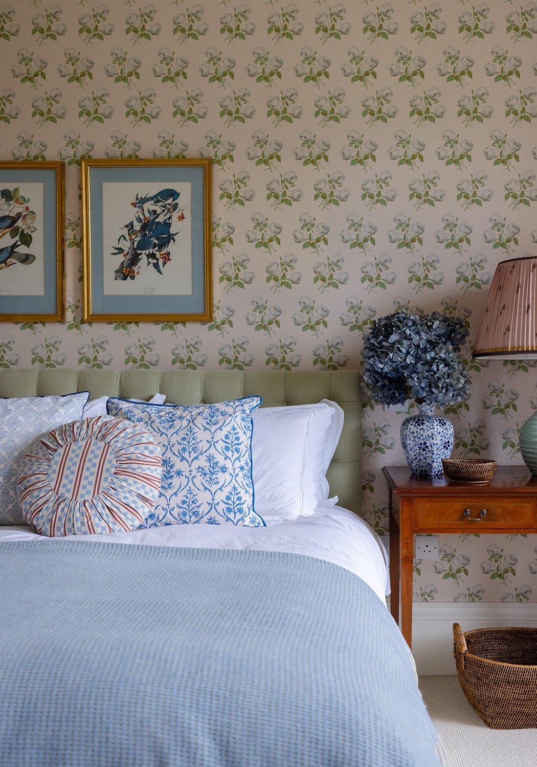 A blue hydrangea bouquet in a classic blue and white porcelain vase on the antonia sky lattice cushion cover
