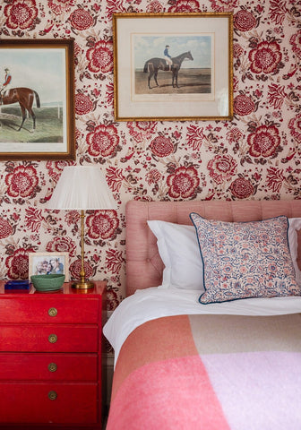 Pink tufted bedhead with white and pink bedding featuring an Antonia Twilight Floral cushion cover