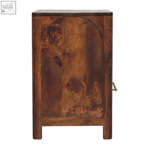 Dark brown wooden arc bedside table with rustic hand carved design and brass handle for bedroom storage