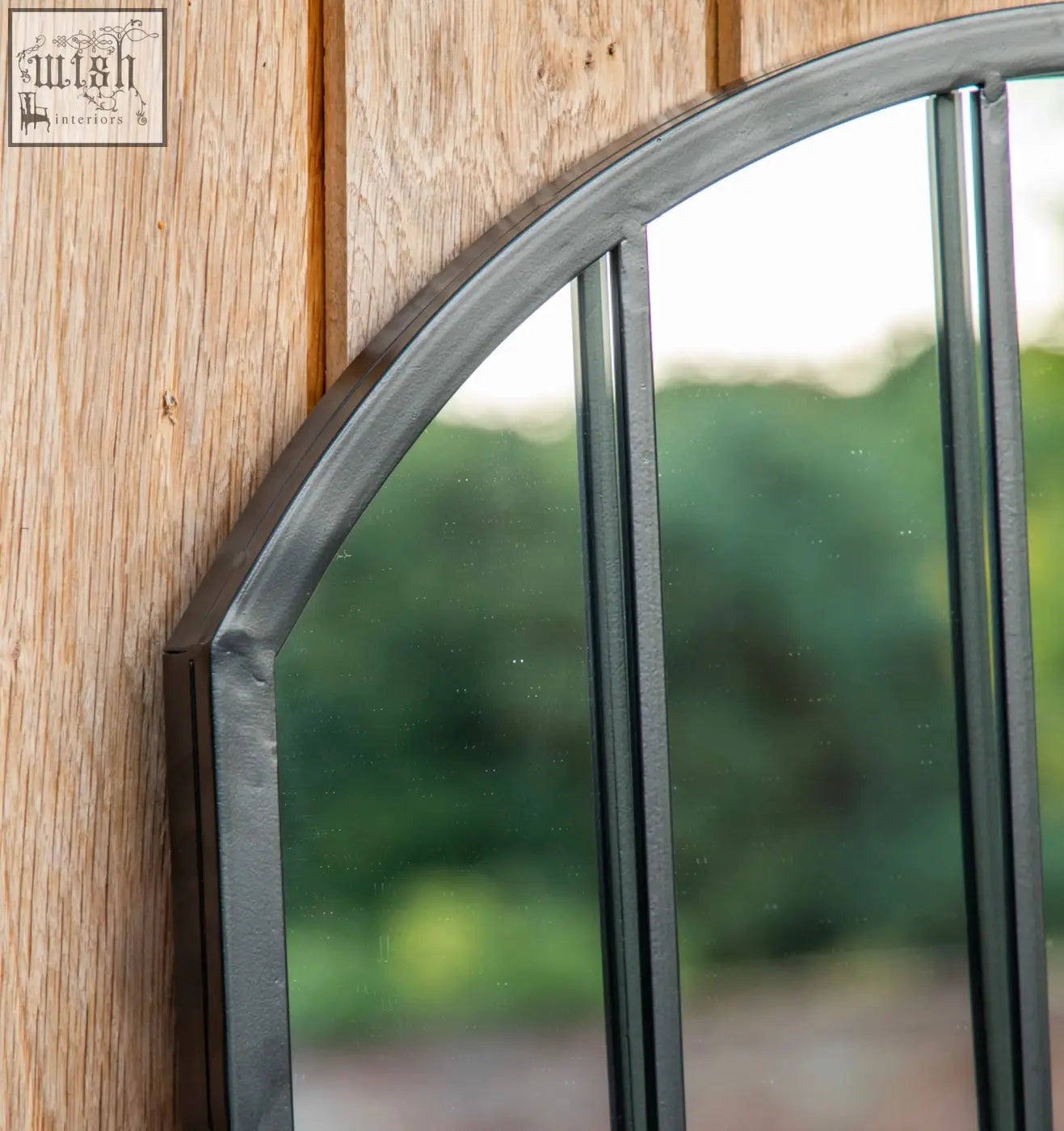 Black wrought iron arched outdoor metal black mirror with window pane design vertical bars and metal black frame