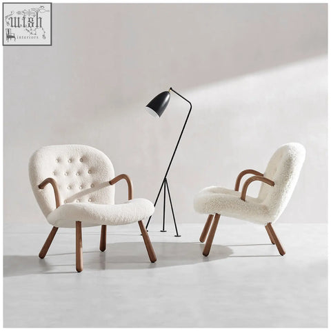 Cream-colored arctander clam armchair with tufted backrest curved wooden arms long hair sheepskin upholstery