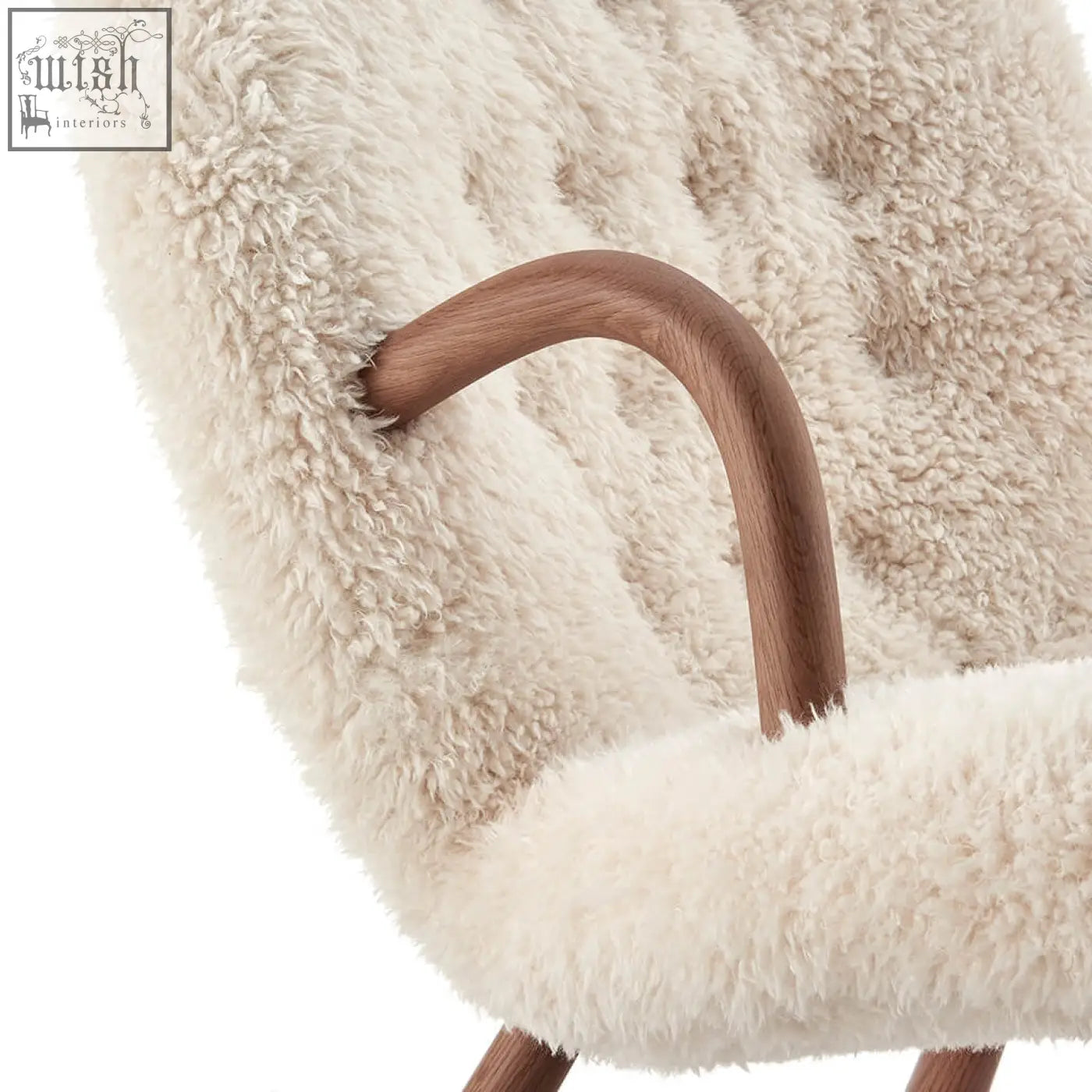 Cream-colored arctander clam armchair sheepskin with smooth curved wooden armrest and long hair texture