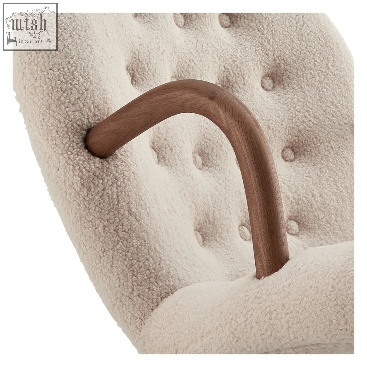 Cream-colored arctander clam armchair with sheepskin upholstery and curved wooden handle for cozy seating