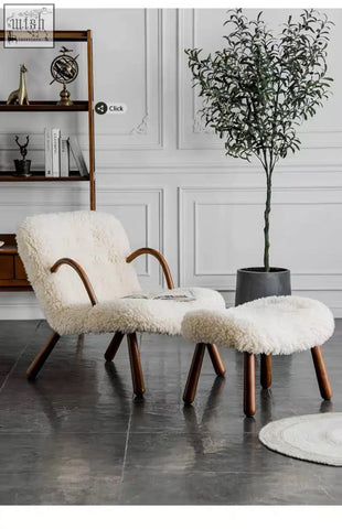 Cream-colored arctander clam armchair sheepskin with curved wooden legs and matching ottoman for cozy lounging