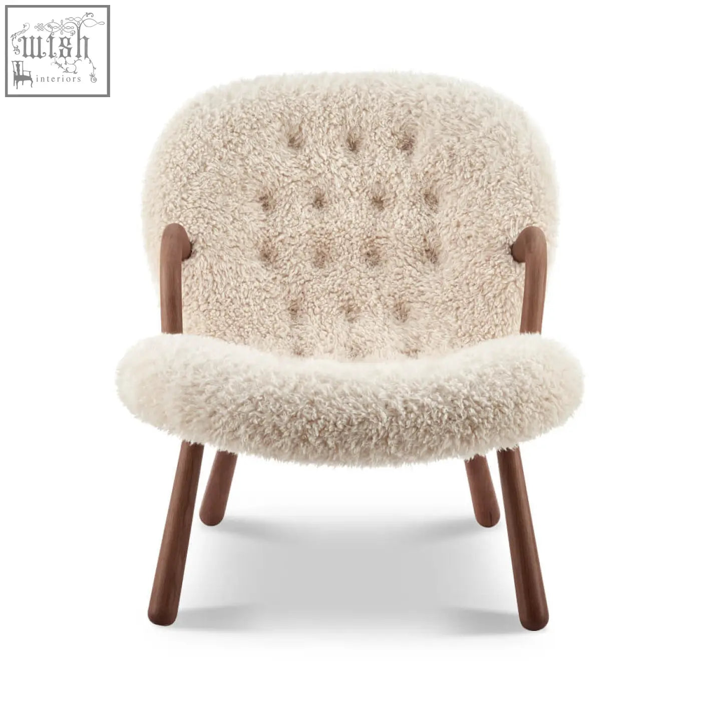 Cream-colored arctander clam armchair with tufted back and wooden legs made from long hair sheepskin