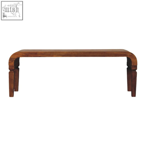 A sleek dark brown oak solid mango wood arcus coffee table bench with curved top perfect for living room use