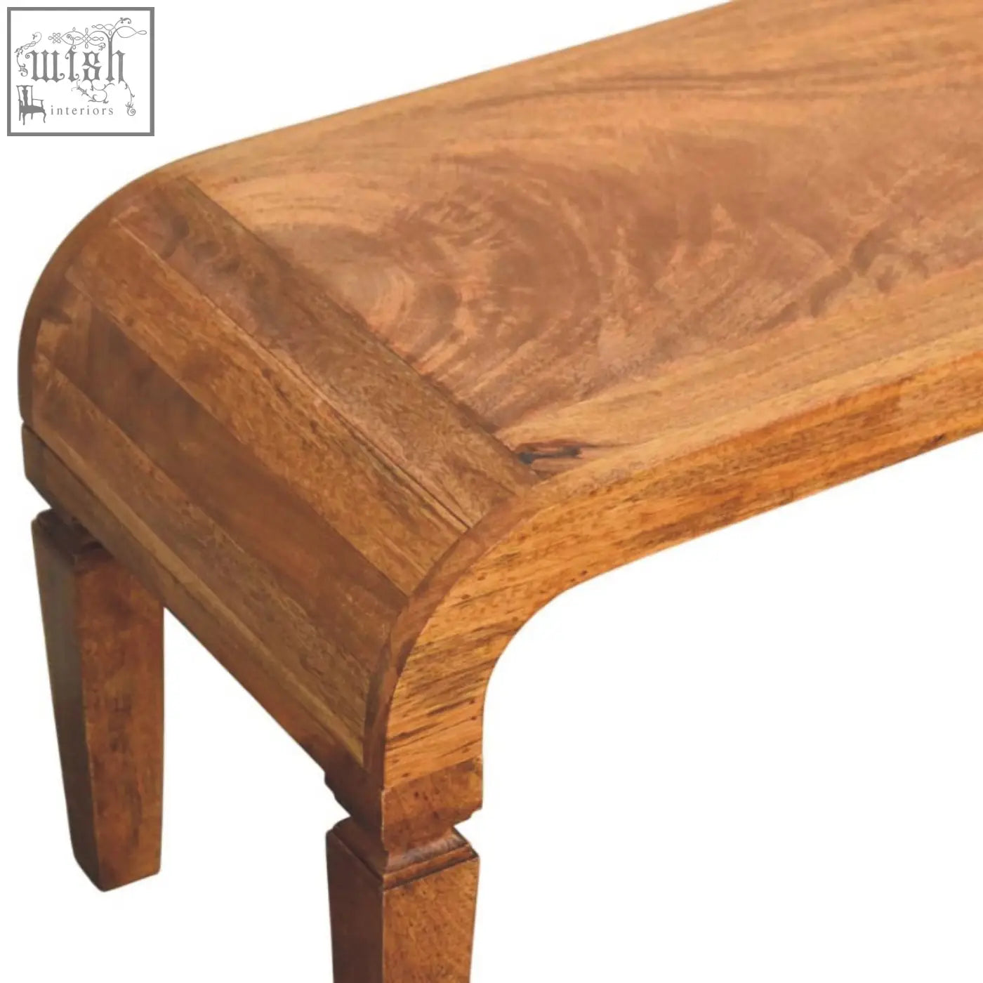 A warm medium-toned oak solid mango wood arcus coffee table with a smooth curved top perfect for the living room