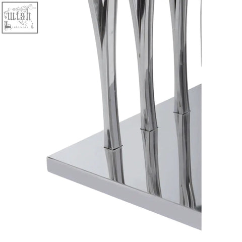 Chrome finished metal table legs of arenza black marble console table with sleek modern design and silver accents