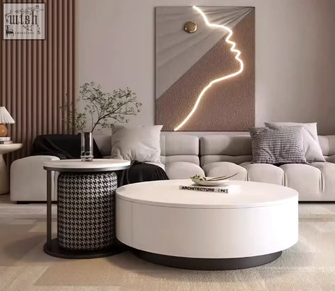 White oval marble coffee table with sleek black base and matching footstool coffee table offers modern style