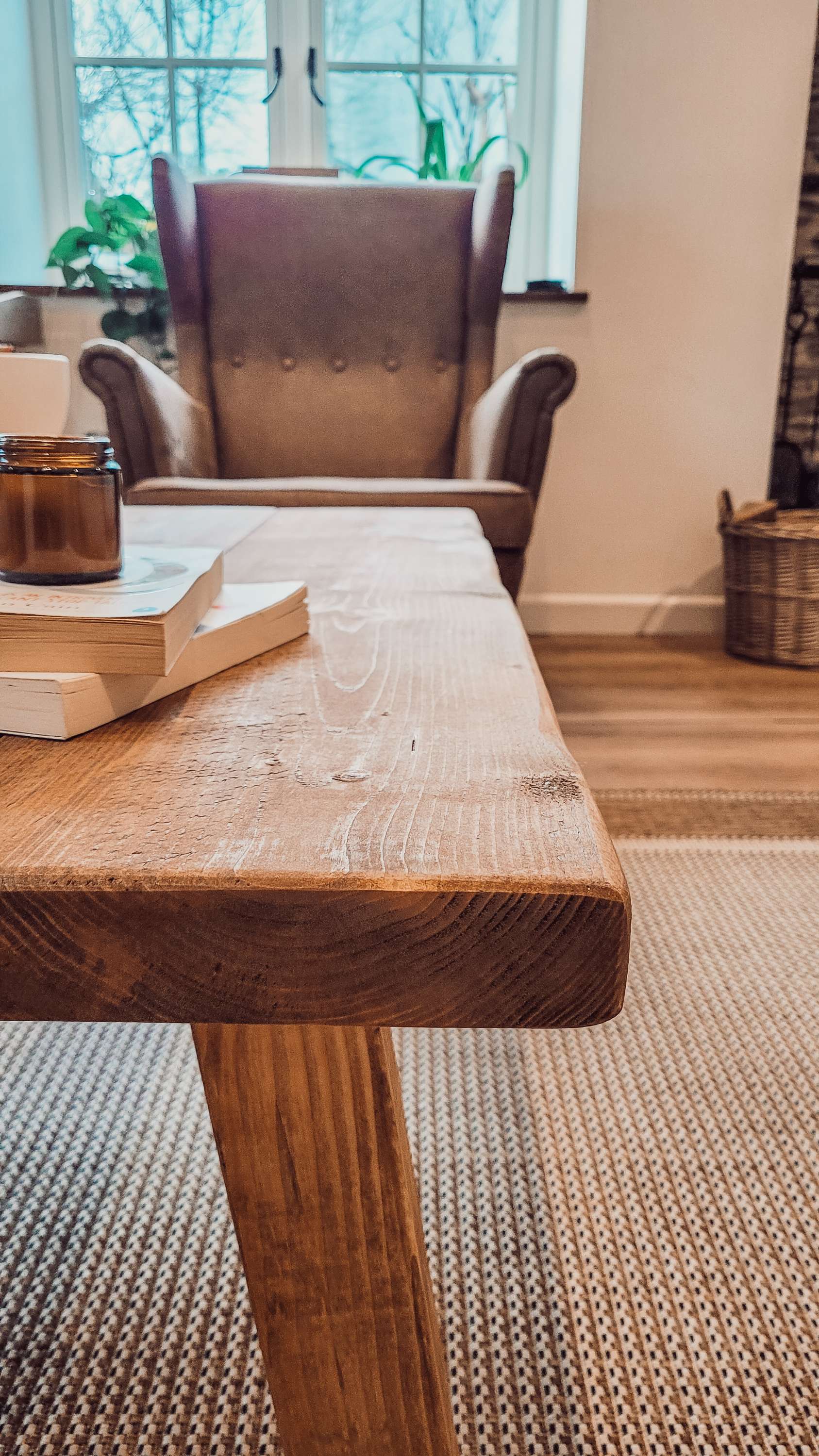 Rustic wooden coffee table with visible grain and sturdy legs in the aria rustic collection pictured table