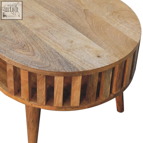 Round ariella coffee table with natural finish and vertical slats base made from solid mango wood