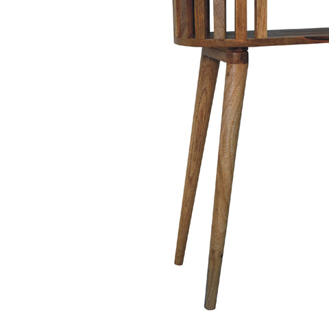 A mid-century modern wooden chair with slender tapered legs and a slatted backrest next to the ariella console table