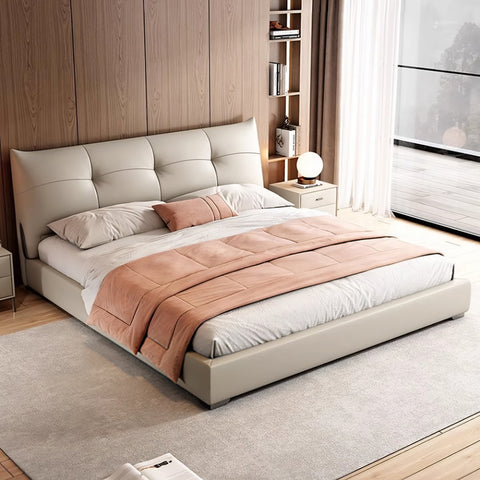 Beige tufted leather king size superking bed with matching headboard and soft peach quilt for cozy bedrooms