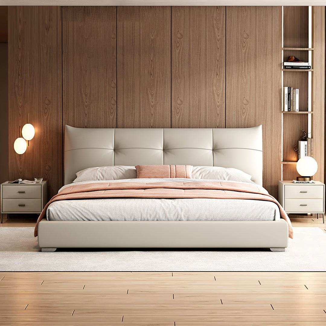 Cream-colored tufted leather arjun king size superking size bed with sleek modern design and matching nightstands