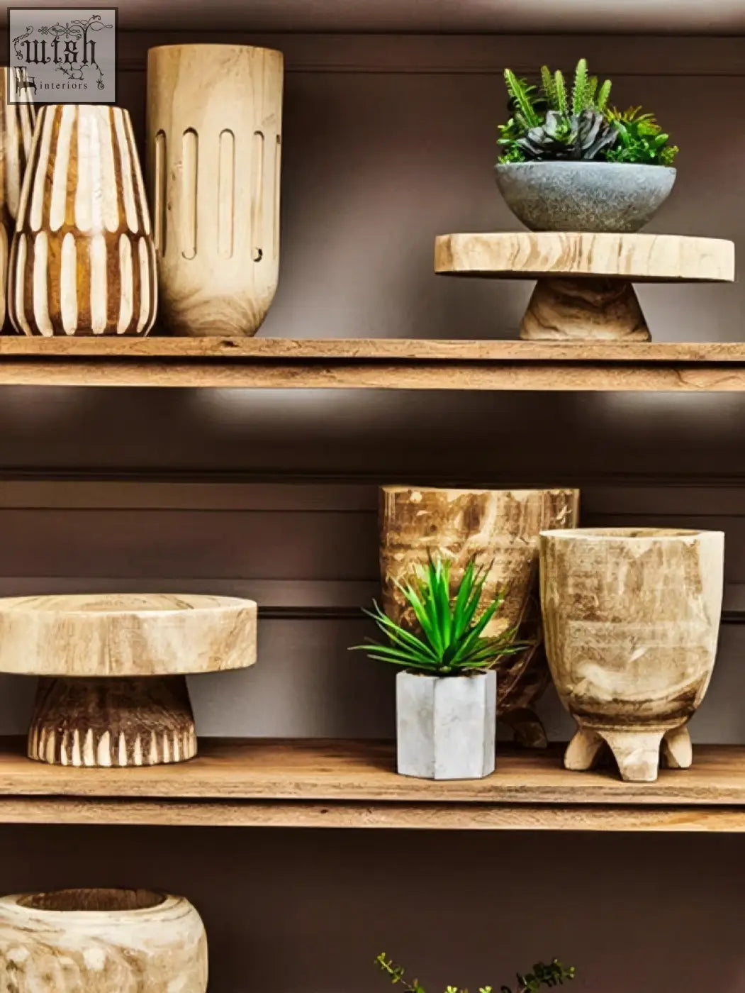 A rustic wooden pedestal with three textured tiers supporting the arlo natural engraved round bowl